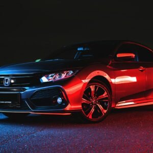 Red Honda Civic sedan under neon light