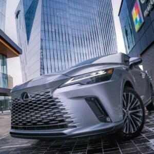 Silver Lexus RX SUV parked in front of a building