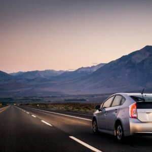 Silver Toyota Prius hybrid on an open road